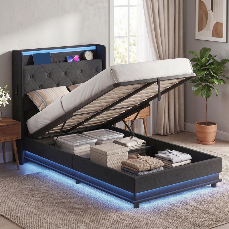 Single ottoman bed with the base lifted showing folded clothes and storage boxes underneath