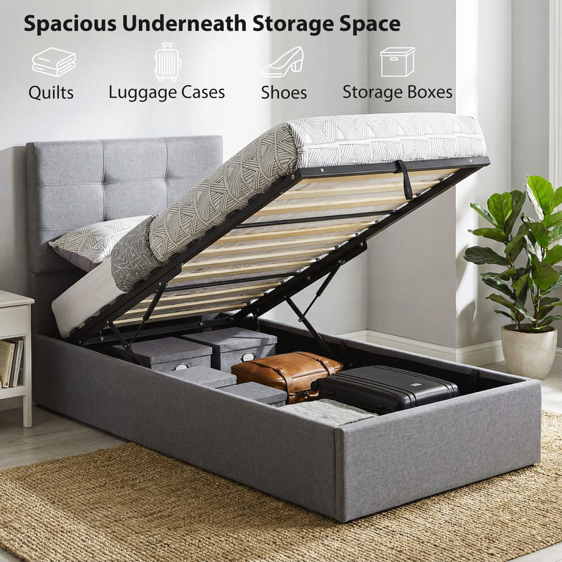 Ottoman bed base lifted open revealing hidden storage holding luggage, shoes and boxes