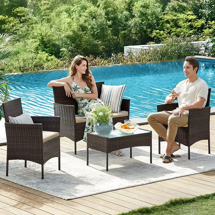 Image of a 4 Piece Brown Rattan Patio Furniture Set With Taupe Cushions