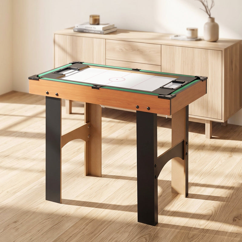 Hockey surface set up on the games table beside a wooden sideboard