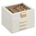 Cloud white 4-layer jewellery box with gold clasp and 3 drawers, closed with jewellery visible under the glass lid