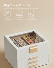 Close view of the transparent glass lid over the top compartment of the white jewellery box