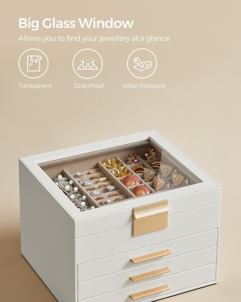 Close view of the transparent glass lid over the top compartment of the white jewellery box
