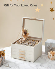 White jewellery box open on a marble surface beside wrapped gift boxes and ribbon