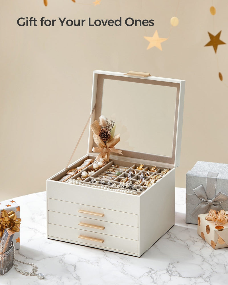 White jewellery box open on a marble surface beside wrapped gift boxes and ribbon