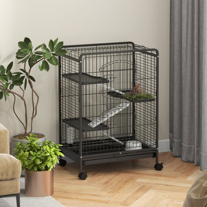 Black small animal cage in a living room beside a plant with a small pet inside
