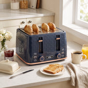 Honeycomb toaster on a breakfast table with toast, jam, coffee and orange juice