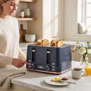 Woman using the honeycomb toaster in a kitchen with coffee and flowers