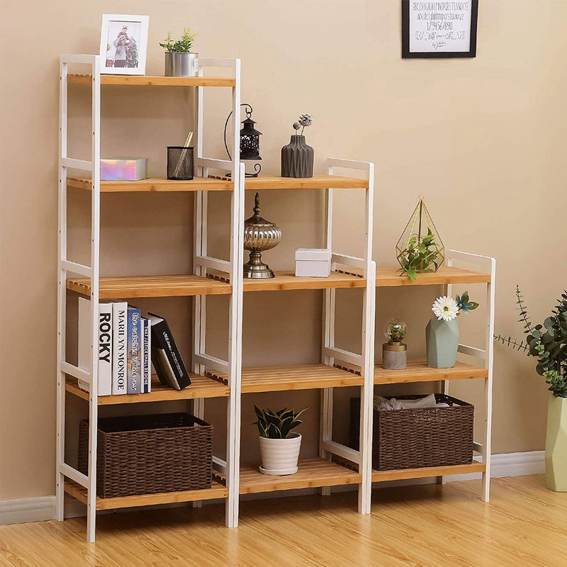 Bamboo shelf units of different heights styled against a beige wall with books and baskets