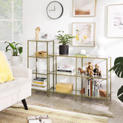 Gold 4 tier glass shelf in a living room beside a matching wider console shelf