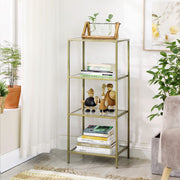 Close view of the gold glass shelving unit holding books, ornaments and plants