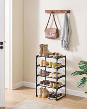 Black 4-tier shoe rack in a hallway corner below a wall hook with a bag and towel