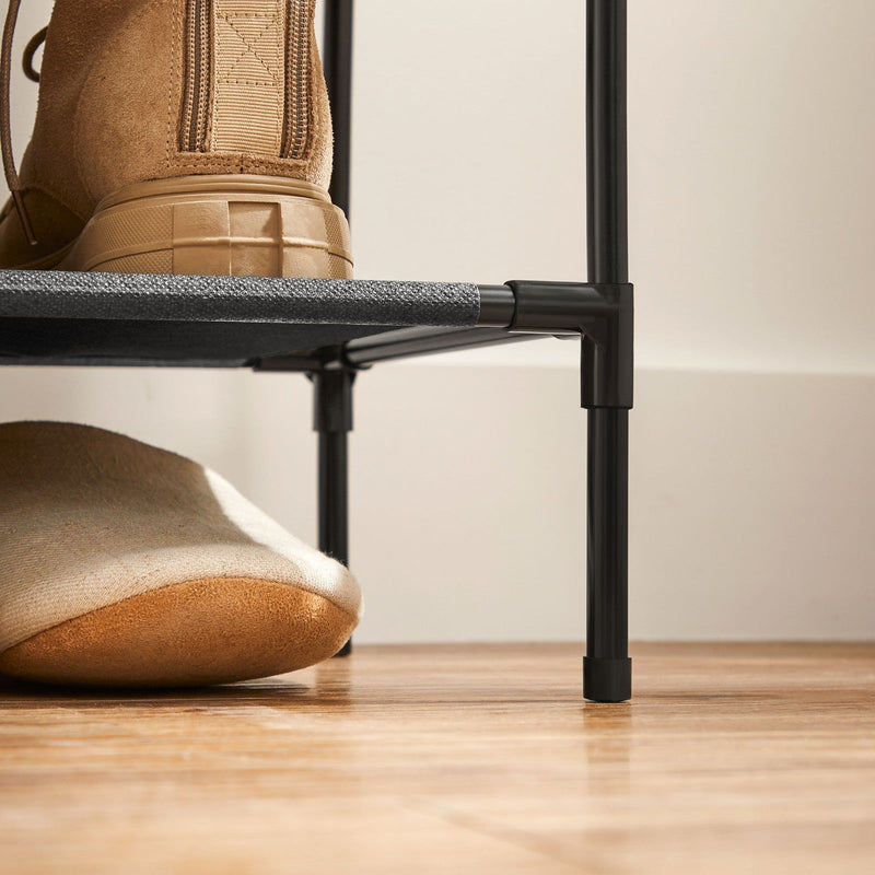 Close-up of a boot resting on a non woven fabric shelf of the shoe rack