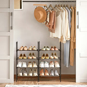 Two black shoe racks side by side in an open wardrobe filled with shoes