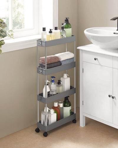 Grey slim trolley holding towels and toiletries in the gap beside a bathroom basin unit