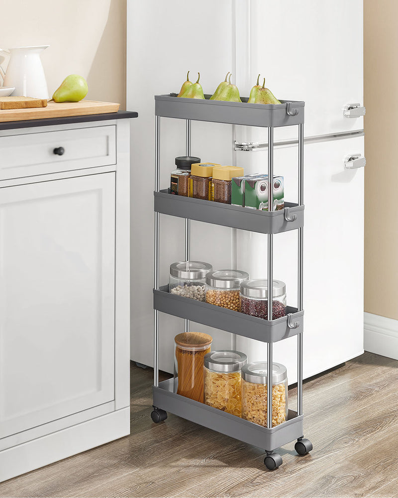 Grey 4-tier trolley filled with pasta and spice jars in a narrow kitchen gap beside a fridge