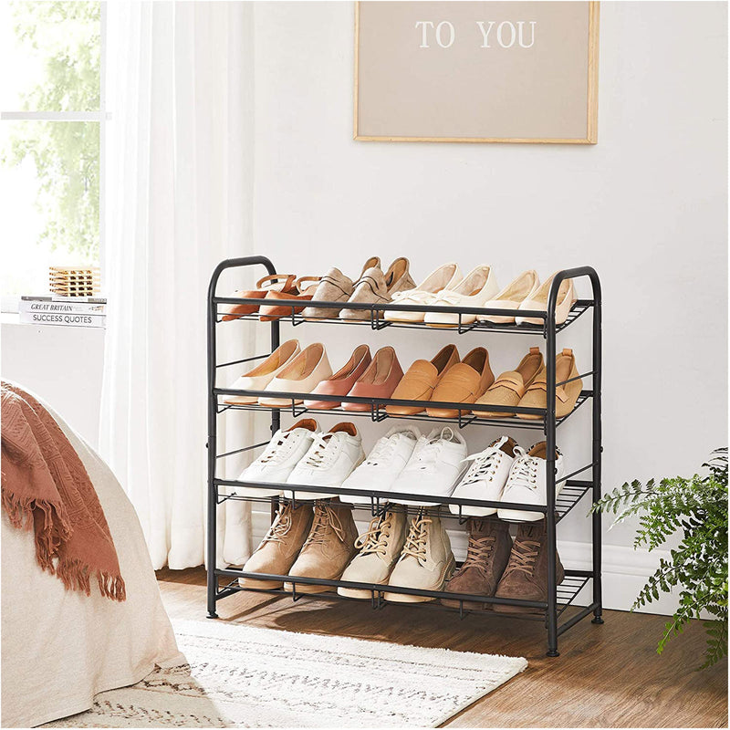 4-tier shoe rack filled with flats, loafers, trainers and boots beside a bed