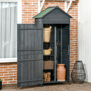 Slim wooden shed open against a brick wall showing shelved baskets, logs and a terracotta pot