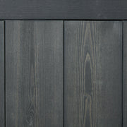 Close-up of the grey-stained fir wood planks and visible grain on the shed panels