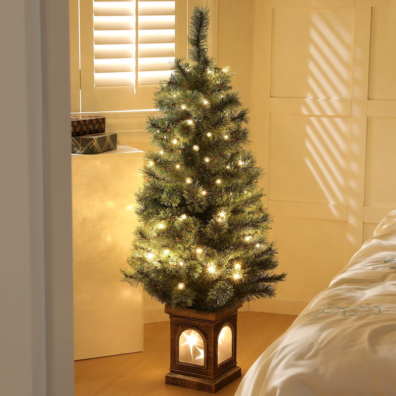 Lit Christmas tree standing by a window with shutters