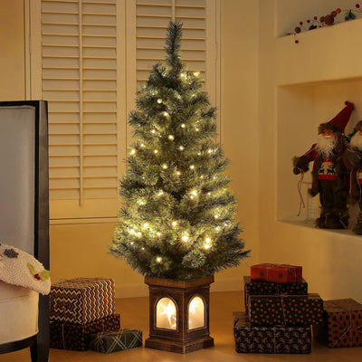 Lit 4ft Christmas tree with warm white LEDs in a living room with gifts