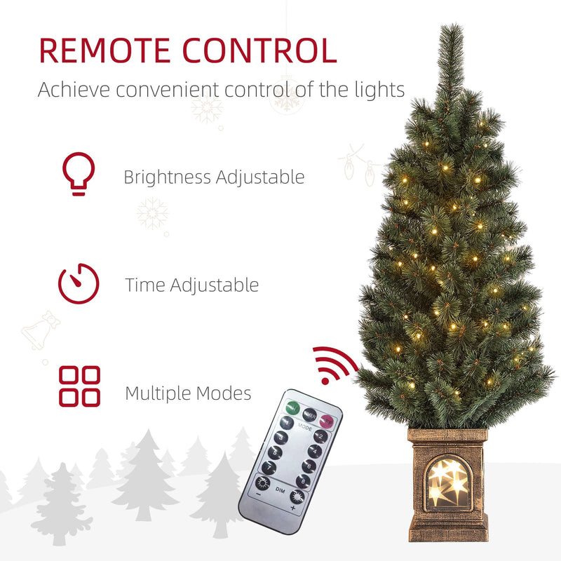 Lit Christmas tree with remote control and icons for brightness, timer and modes
