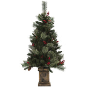 Studio shot of a 4ft green Christmas tree with red berries and pine cones in a bronze retro base