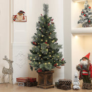 Lit tree in a hallway with a reindeer figure and Santa figures