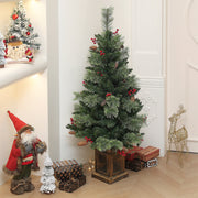 Unlit tree in a hallway corner beside a Santa figure and wrapped gifts
