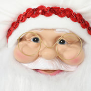 Close-up of chef Santa's face with glasses and red sequin hat band