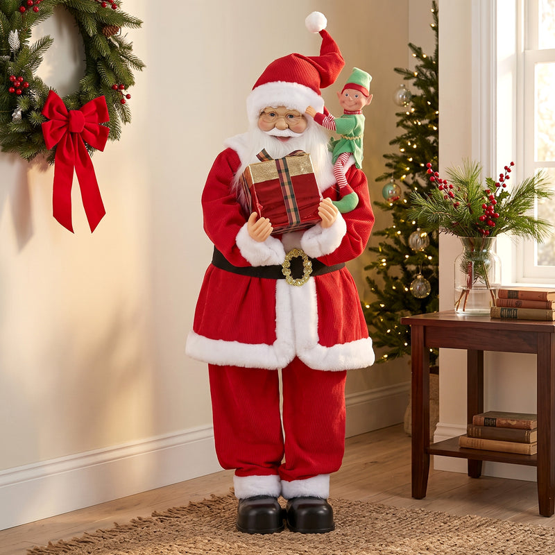 Santa figure beside a wreath, side table and Christmas greenery