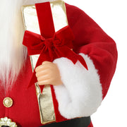 Close-up of Santa's gold-tone gift box with red velvet bow