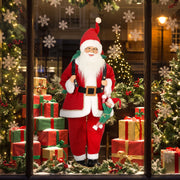 Santa figure in a shop window with gifts and snowflakes