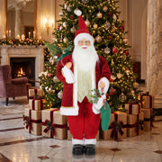 Santa figure beside a decorated Christmas tree and gift boxes