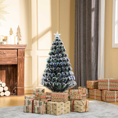 Tree in a room with a wooden fireplace and stacked gifts
