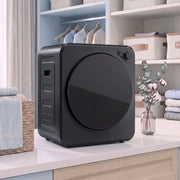 Black 4kg tumble dryer on a countertop in a home laundry nook