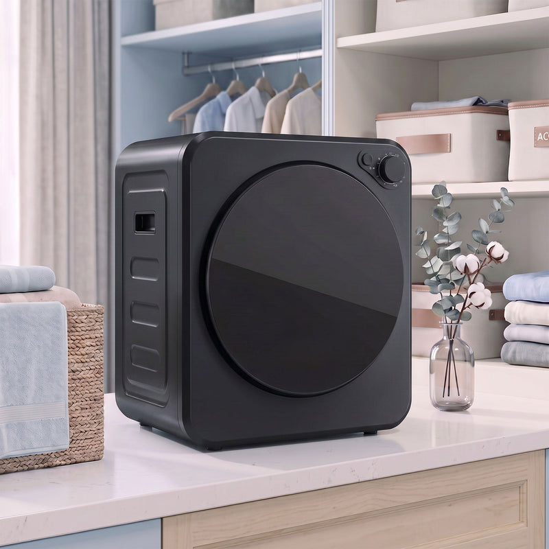 Black 4kg tumble dryer on a countertop in a home laundry nook