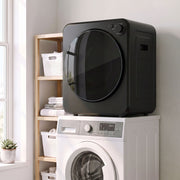 Black tumble dryer stacked on top of a washing machine in a laundry room