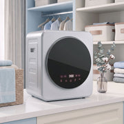 Silver tumble dryer on a countertop in a home laundry nook