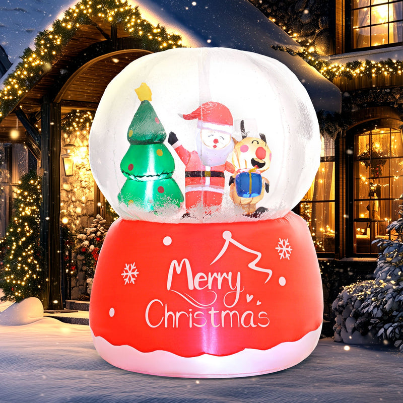 Glowing snow globe inflatable beside a doorway with string lights at night