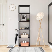 Cube shelving unit in a hallway holding shoes and boxes beside an umbrella and hat stand