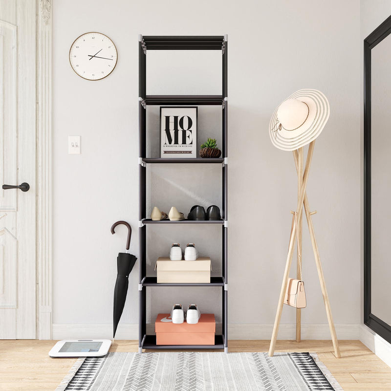 Cube shelving unit in a hallway holding shoes and boxes beside an umbrella and hat stand