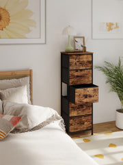 Chest of drawers beside a bed with the middle fabric drawer pulled open