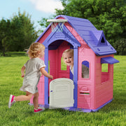 Two children playing at the working front door of the pink Aiyaplay playhouse outdoors