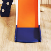 Close-up of the orange slide chute and navy base on a wooden floor