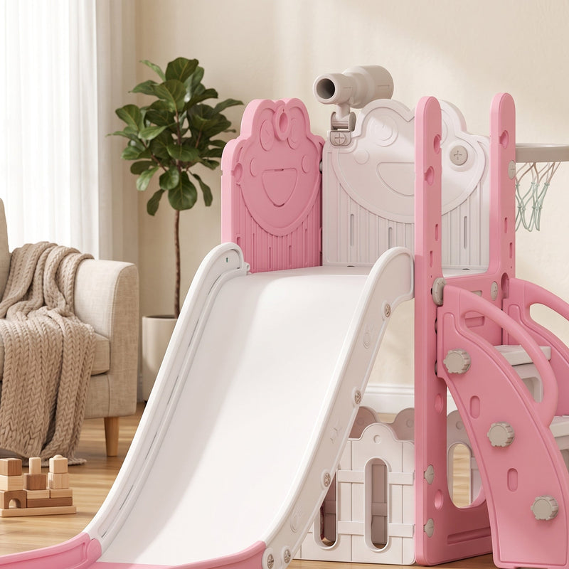 Pink and cream 5 in 1 slide set shown in a living room beside a plant