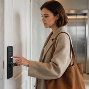 Woman using the fingerprint sensor to enter a building