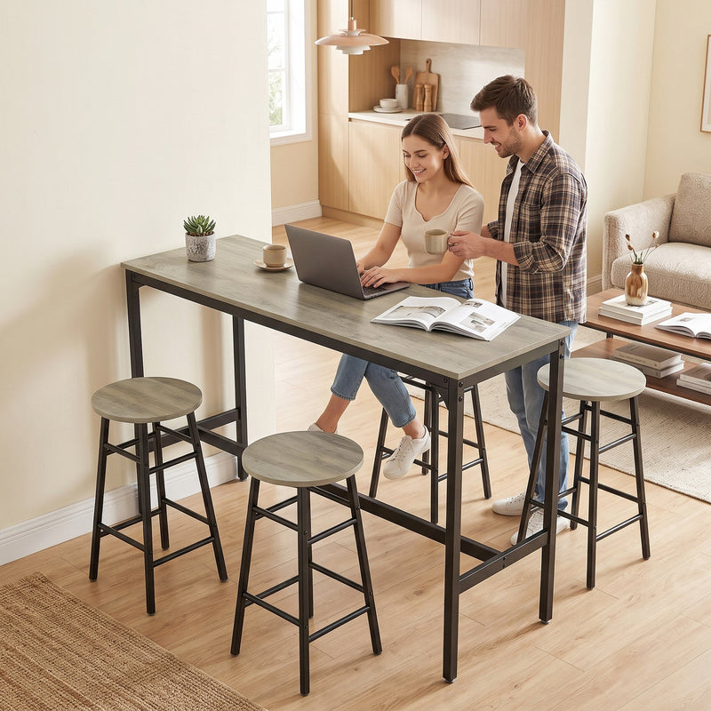 Couple using the bar table as a laptop workspace at home