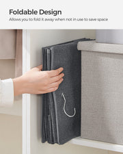 Foldable design panel showing a hand folding the grey organiser flat for storage