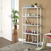 White bamboo shelf used as a hallway shoe rack beside the front door
